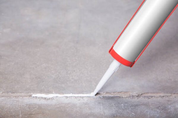 Sealant gun crack covers the crack in the floor of the wall tile concrete